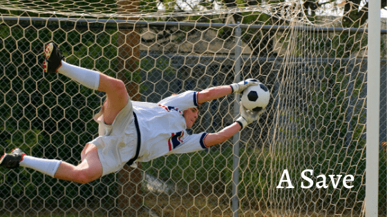goalkeeper saving a shot at goal